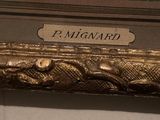 a sign that says p migard on the side of a wall