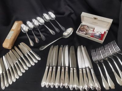 a lot of silverware on a table with a box