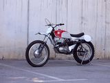 a white and red motorcycle parked in a parking lot