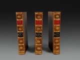 a pair of antique books on a grey background