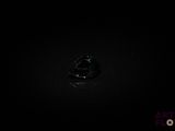 a close up of a ring in the dark with a black background
