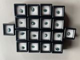 a lot of green eyes that are in a display case