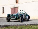 a green car that is parked in front of a building