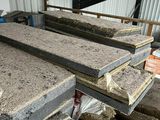 several pieces of concrete are stacked on top of each other in a warehouse
