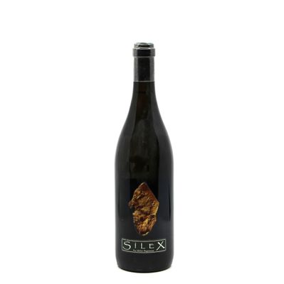 a bottle of wine sitting on top of a white surface