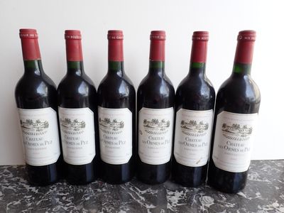 six bottles of wine are lined up on a table