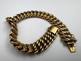 a close up of a gold bracelet with a clasp on it