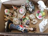 a cardboard box filled with a variety of decorative items