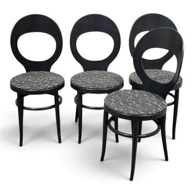 three black chairs with a patterned seat and back rest