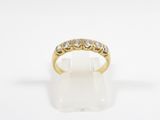 a yellow gold ring with five diamonds on a white background