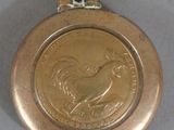 a gold coin with a bird on it on a table