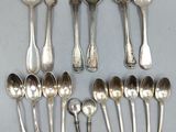 silver plated spoons and spoons arranged in a circle on a table