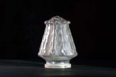 a glass vase that is sitting on a table