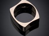 a close up of a silver ring on a black surface
