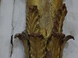a gold vase on the wall of a building