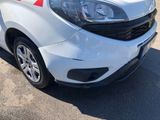 a white van with a red stripe parked in a parking lot