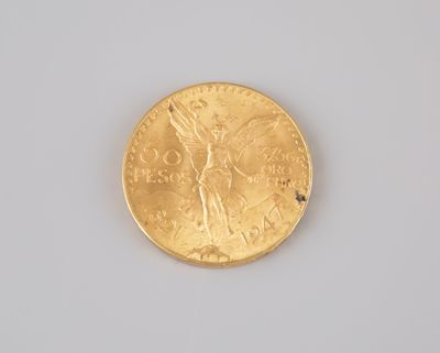 a gold coin with a lady on it on a white surface