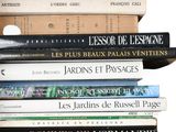 many books stacked on top of each other on a shelf
