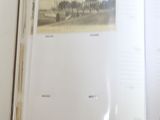 an open book with a picture of a city in it
