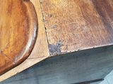 a close up of a wooden table with a piece of wood on top of it