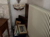 a radiator in the corner of a room next to a table