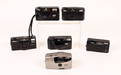 four different types of cameras on display on a white surface