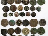 a collection of ancient roman coins on a white surface