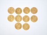 several gold coins arranged in the shape of a heart on a white surface