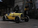 a yellow car that is parked inside of a building