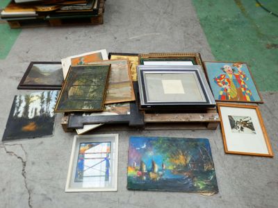 a lot of framed art on the floor in a room