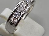 a close up of a diamond ring on a white marble stand