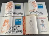several pages of comic books are lined up on a table