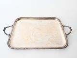 an old silver tray with handles on a white surface