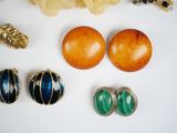 many different types of jewelry on a white surface