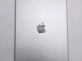 an apple ipad sitting on top of a table next to a white wall