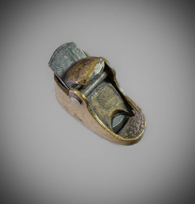 a metal object that is on a white surface