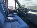 the interior of a truck with blue seats and a steering wheel