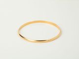 a close up of a gold ring on a white surface