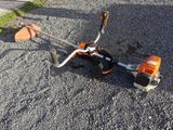 a small lawn mower that is laying on the ground