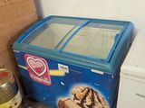 an ice cream machine and a freezer in the corner of a room