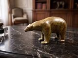 a statue of a bear sitting on a marble table