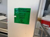 a green sign on the door of a kitchen