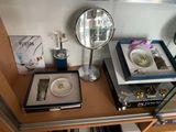 a desk with a mirror, a plate, and other items on it