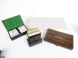 three dice pieces in a box on a white table
