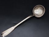 a silver spoon with a spoon handle on a black surface
