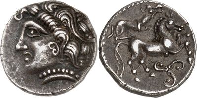 a close up of a coin with a face on it