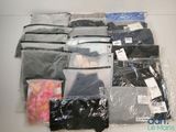 a lot of clothes that are sitting on a table