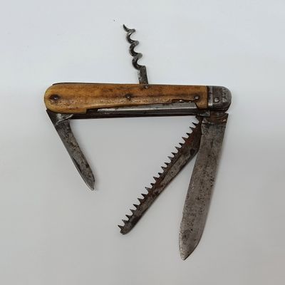 a small knife with a wooden handle on a white surface