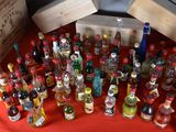 many bottles of alcohol sitting on a red table