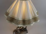 a lamp that is sitting on a table next to a lamp shade
